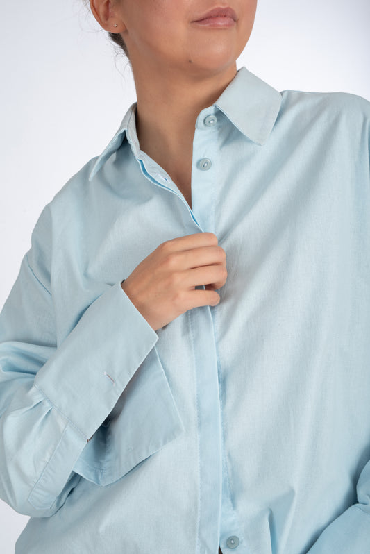 Understated straight-fit shirt with embroidered sleeve logo, featuring a minimalist collar, hidden placket, and tailored cuffs. Precision stitching, reinforced fabric, and sleek design for a polished, versatile look